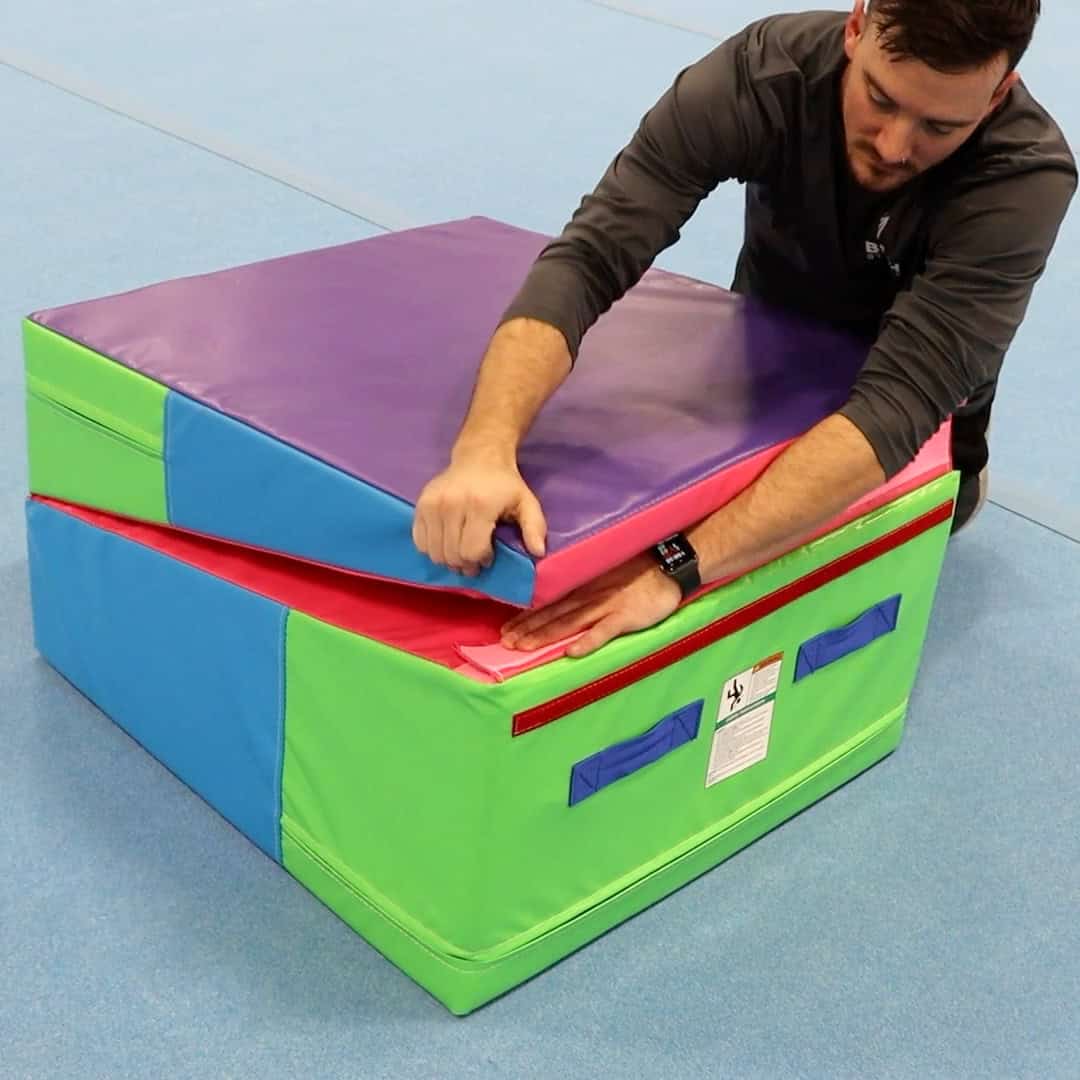 A photo showing a man folding a Folding Incline Mat